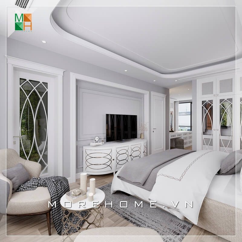 Đan xen giữa sắc trắng chủ đạo của căn phòng ngủ là bộ bàn 1 ghế sofa màu kem rất sang trọng làm tăng độ tiện nghi cho căn phòng ngủ tân cổ điển